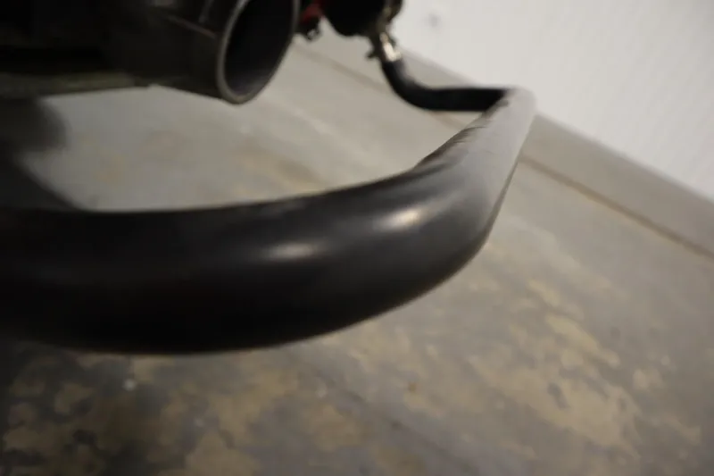 Slide: The Image of Close-up of a 2018 Yamaha GP1800 jet ski component, focusing on a black metal bar. - 23