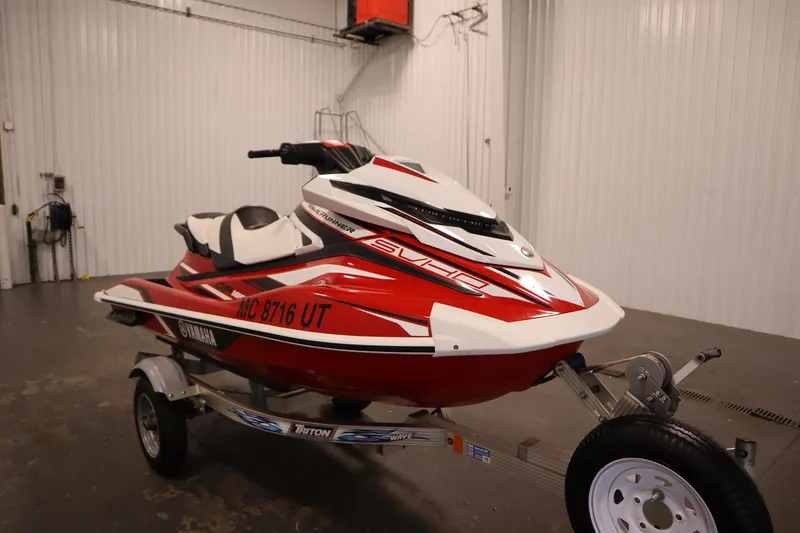Slide: The Image of 2018 Yamaha GP1800 jet ski in red and white on a trailer in a garage. - 3