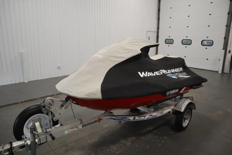 Slide: The Image of 2018 Yamaha GP1800 WaveRunner covered on trailer in garage setting. - 32