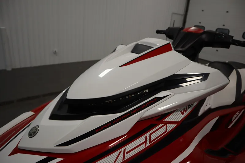 Slide: The Image of 2018 Yamaha GP1800 jet ski, white and red, in indoor setting. - 9