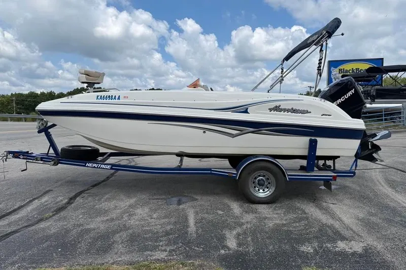Slide: The Image of 2006 Hurricane GS194 Fundeck boat on trailer, parked outdoors under cloudy sky. - 4