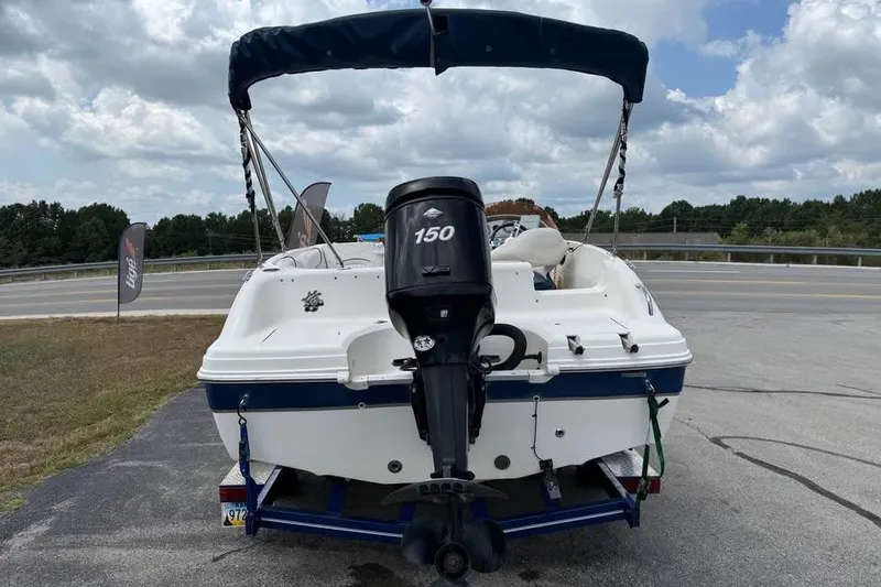 Slide: The Image of 2006 Hurricane GS194 Fundeck boat with 150 HP engine on trailer, parked outdoors. - 5