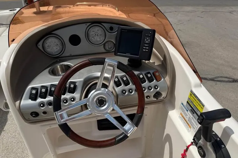 Slide: The Image of 2006 Hurricane GS194 Fundeck boat dashboard with steering wheel and controls. - 8