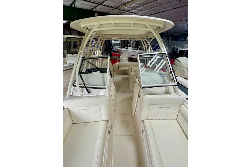 Slide: The Image of 2026 Grady-White Freedom 235 boat interior with seating and windshield in showroom. - 10