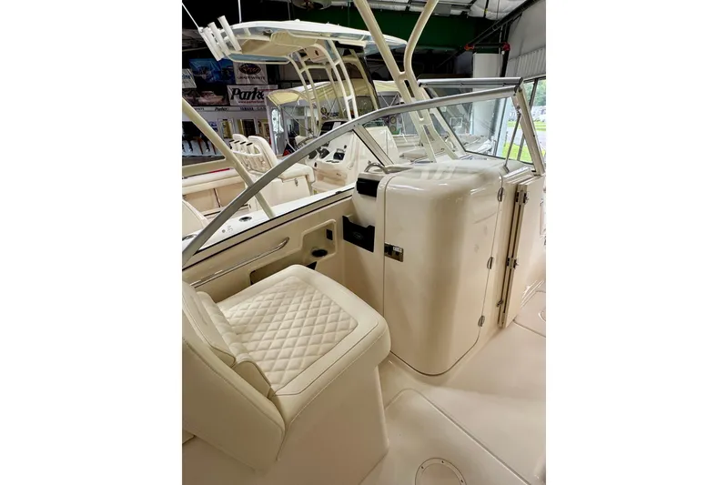 Slide: The Image of Interior of 2026 Grady-White Freedom 235 boat, featuring luxurious seating and helm area. - 5