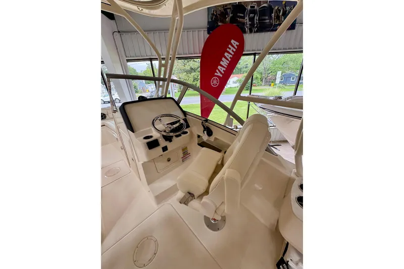 Slide: The Image of 2026 Grady-White Freedom 235 boat interior with steering wheel and Yamaha banner. - 6