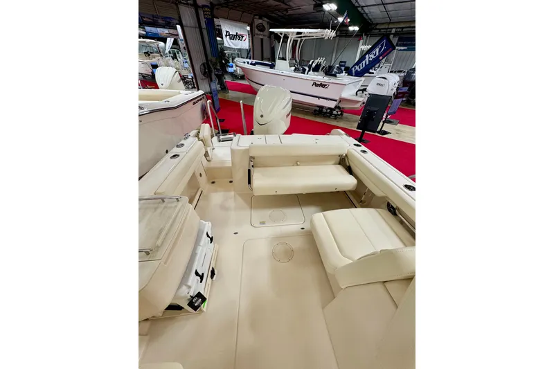Slide: The Image of 2026 Grady-White Freedom 235 boat interior with seating, showcased at a boat exhibition. - 7