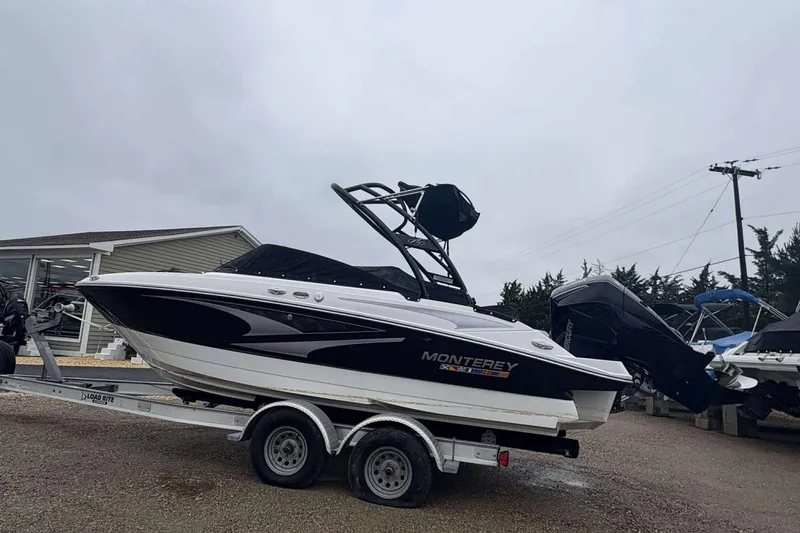 Slide: The Image of 2024 Monterey M205 boat on trailer, parked outdoors on a cloudy day. - 5