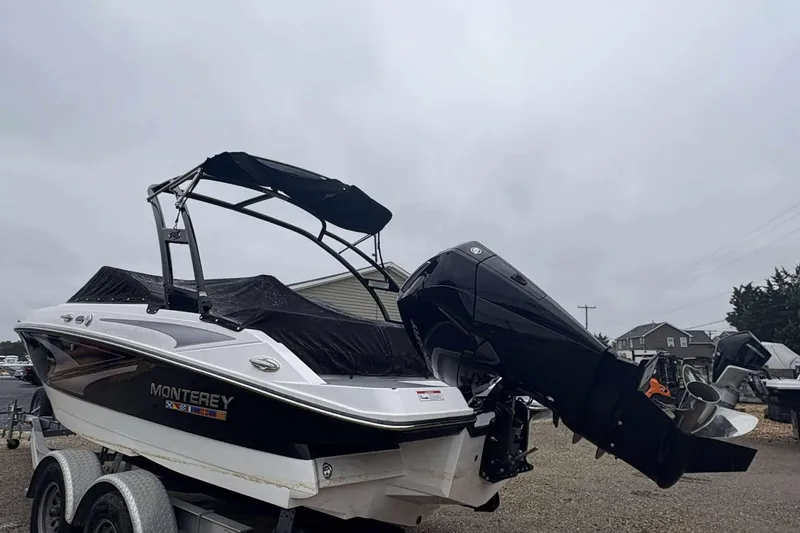 Slide: The Image of 2024 Monterey M205 boat with outboard motor on a trailer, overcast sky. - 6