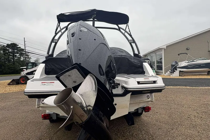 Slide: The Image of 2024 Monterey M205 boat with covered seating and visible propeller, parked outdoors. - 7