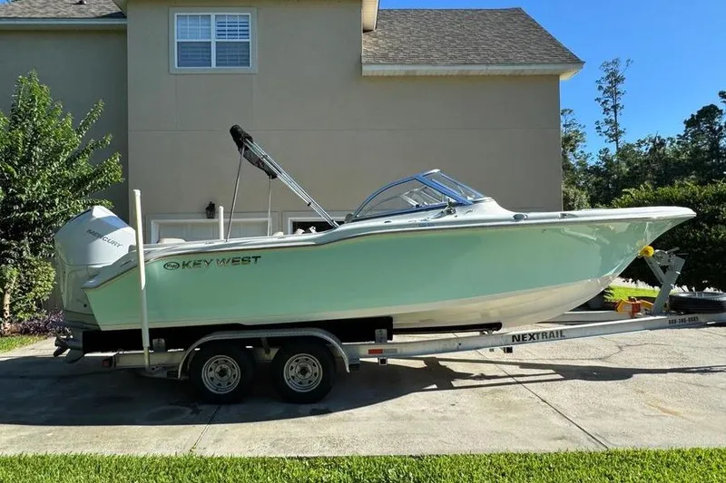 The Image of 2021 Key West 239 DFS boat on trailer, parked in driveway, sunny day. - 0