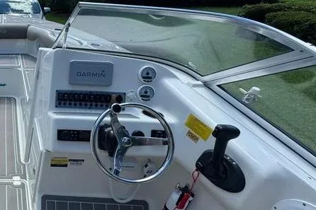 Slide: The Image of 2021 Key West 239 DFS boat dashboard with Garmin navigation system and steering wheel. - 13