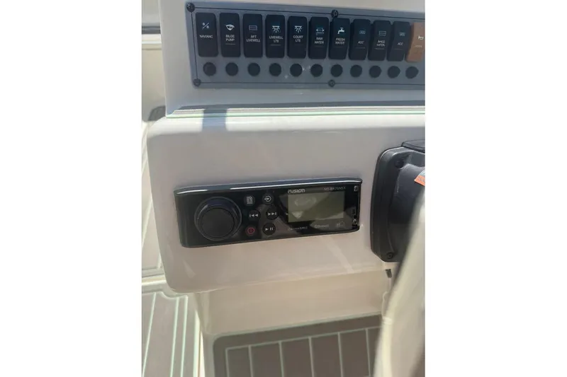Slide: The Image of Control panel of 2021 Key West 239 DFS boat with audio system and switches. - 16