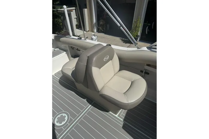 Slide: The Image of 2021 Key West 239 DFS boat seat with beige upholstery and KW logo. - 17