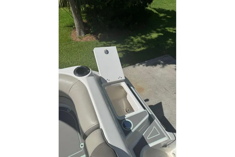 Slide: The Image of 2021 Key West 239 DFS boat interior with open storage compartment and cup holder. - 25