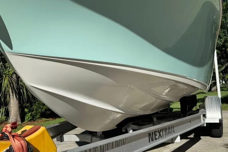 Slide: The Image of 2021 Key West 239 DFS boat on trailer, showcasing sleek hull design. - 4