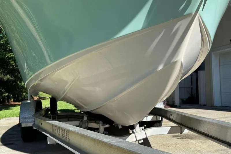 Slide: The Image of 2021 Key West 239 DFS boat on trailer, showing hull design in sunlight. - 5