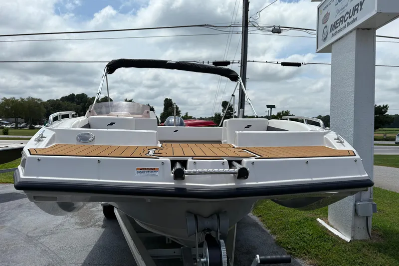 Slide: The Image of 2021 Starcraft SVX 171 OB boat displayed outdoors, featuring a sleek design and wooden deck. - 2