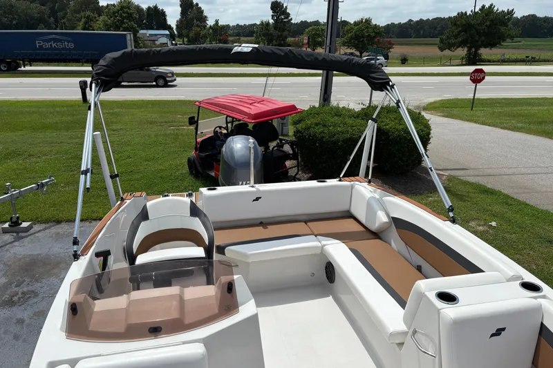 Slide: The Image of 2021 Starcraft SVX 171 OB boat with seating and canopy, parked near a road. - 5