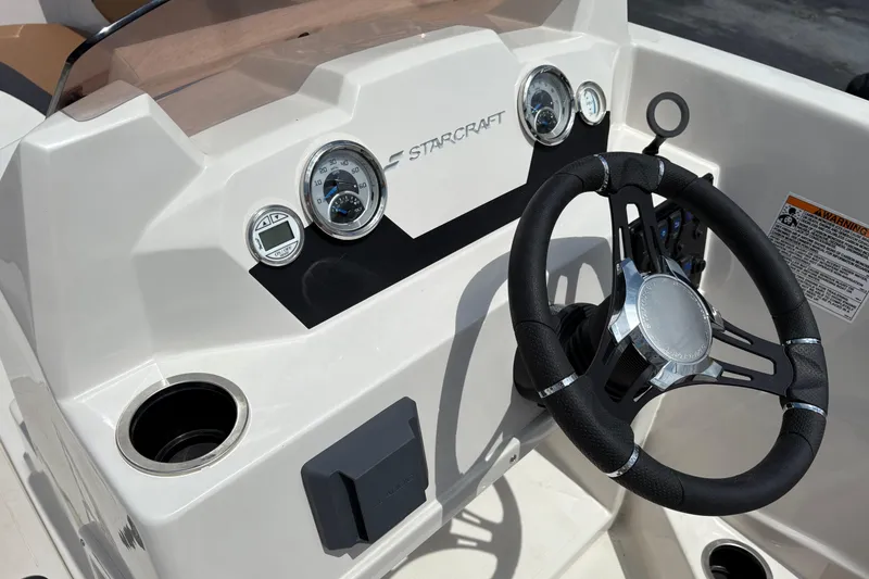 Slide: The Image of 2021 Starcraft SVX 171 OB boat dashboard with steering wheel and gauges. - 7