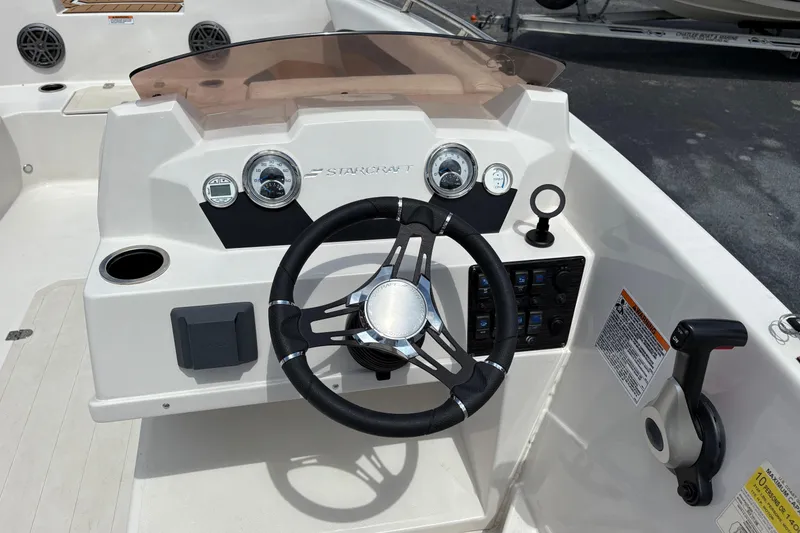 Slide: The Image of 2021 Starcraft SVX 171 OB boat dashboard with steering wheel and control panel. - 8