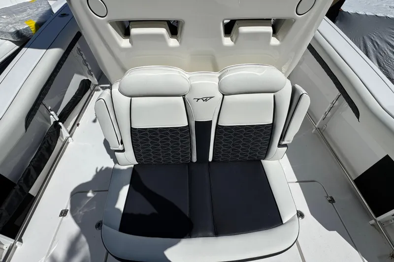 Slide: The Image of 2025 Tidewater 282 CC Adventure boat seating, featuring sleek black and white upholstery design. - 10