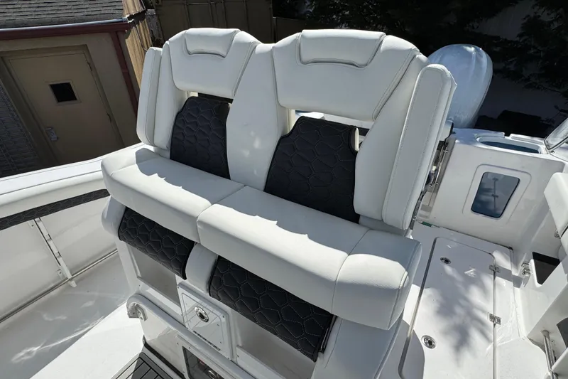 Slide: The Image of 2025 Tidewater 282 CC Adventure boat with luxurious white seating and modern design. - 12