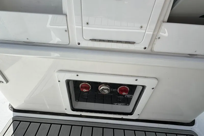 Slide: The Image of Control panel on 2025 Tidewater 282 CC Adventure boat, featuring switches and dials. - 13