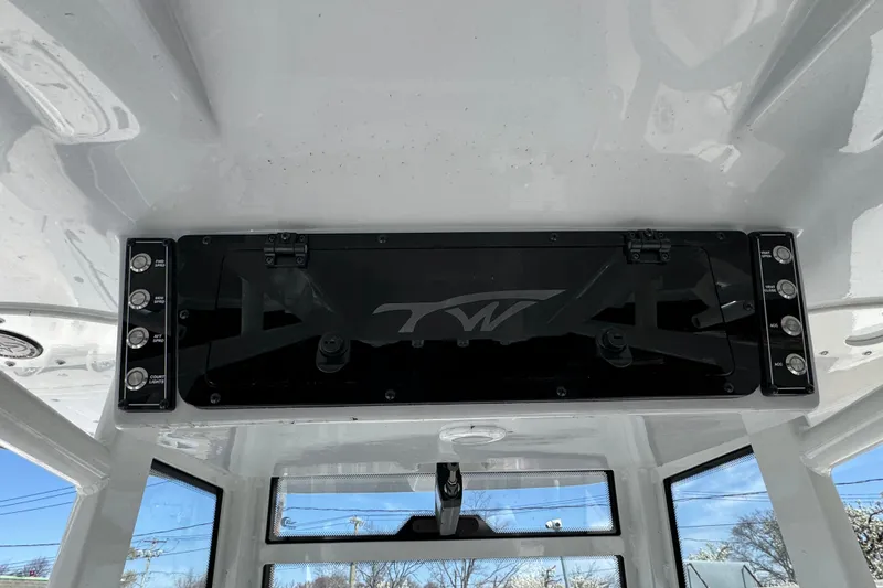 Slide: The Image of 2025 Tidewater 282 CC Adventure boat console with control panel and storage compartment. - 16