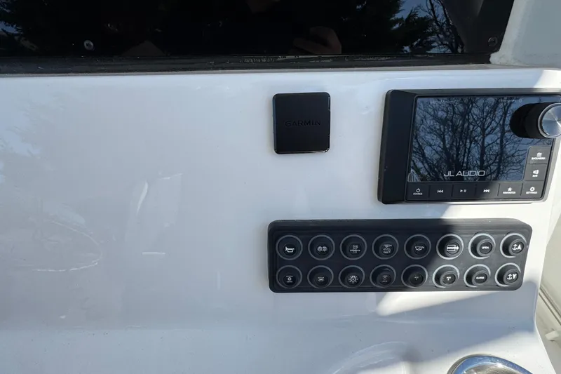 Slide: The Image of Control panel of 2025 Tidewater 282 CC Adventure boat with Garmin and JL Audio systems. - 17