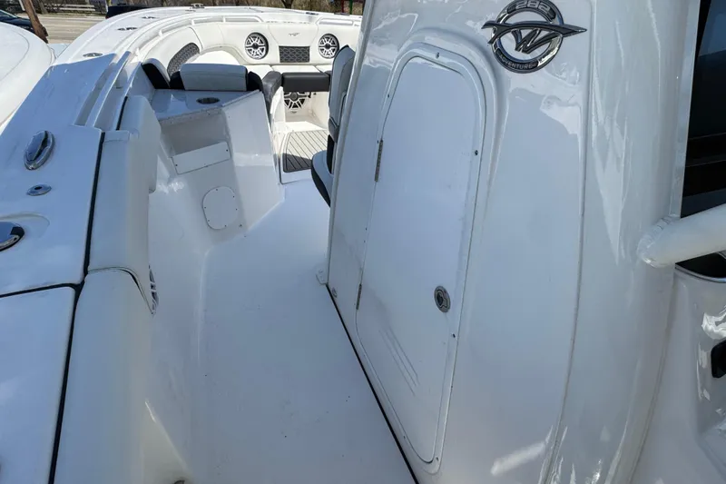 Slide: The Image of 2025 Tidewater 282 CC Adventure boat interior with seating and storage compartment. - 20