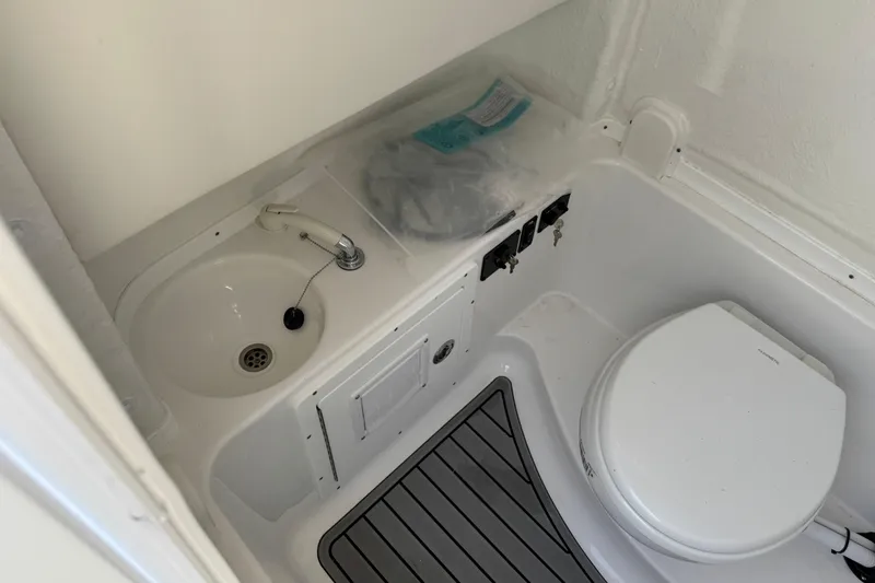 Slide: The Image of 2025 Tidewater 282 CC Adventure boat bathroom with sink and toilet. - 21