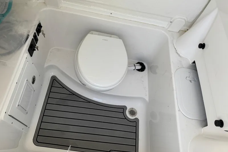 Slide: The Image of 2025 Tidewater 282 CC Adventure boat interior with toilet and non-slip flooring. - 22