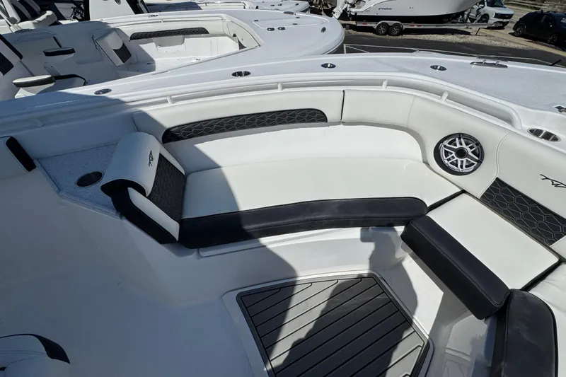 Slide: The Image of 2025 Tidewater 282 CC Adventure boat interior with cushioned seating and speaker. - 26