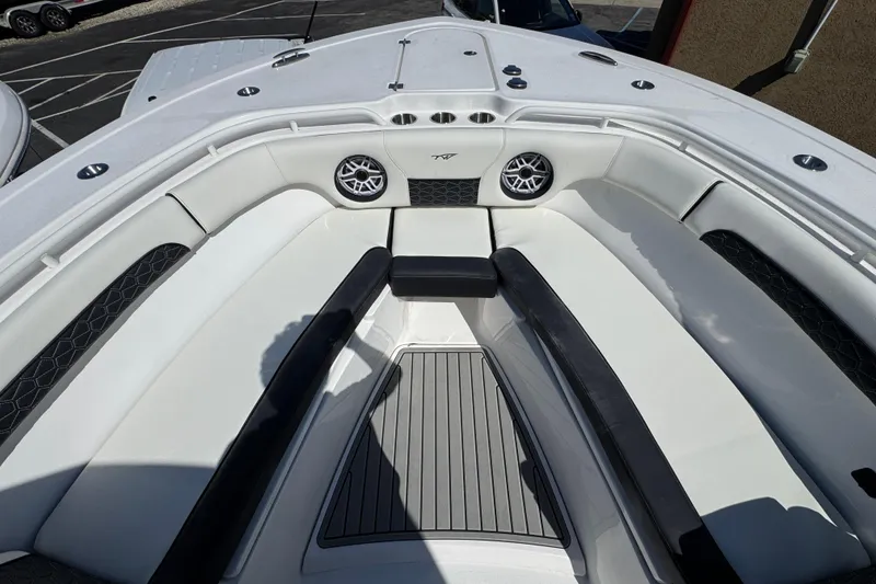 Slide: The Image of 2025 Tidewater 282 CC Adventure boat interior with white seating and speakers. - 28