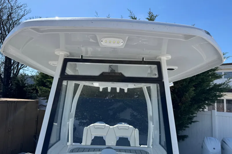 Slide: The Image of 2025 Tidewater 282 CC Adventure boat with T-top and windshield, outdoor setting. - 31