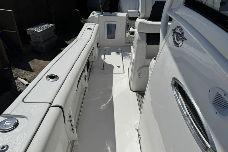 Slide: The Image of 2025 Tidewater 282 CC Adventure boat interior, showcasing sleek white seating and modern design. - 32