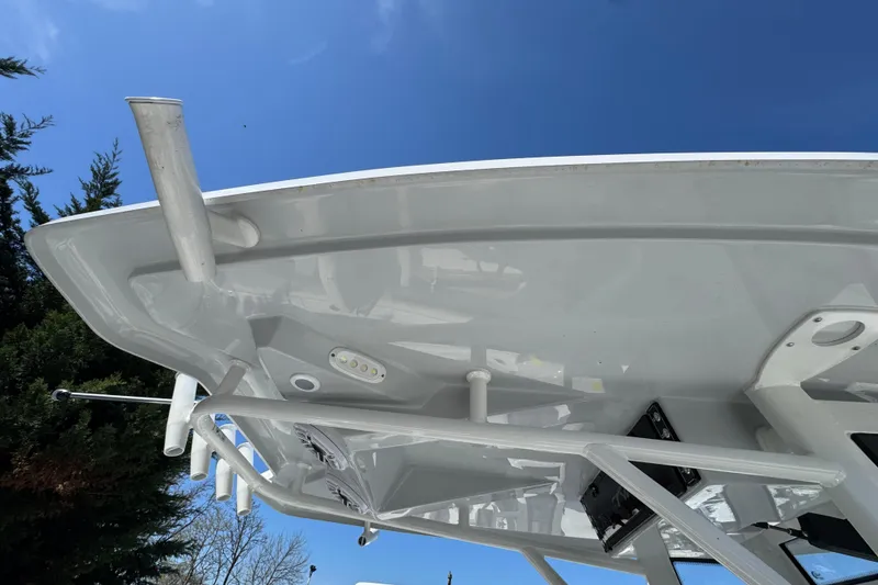 Slide: The Image of 2025 Tidewater 282 CC Adventure boat, viewed from below against a clear blue sky. - 34
