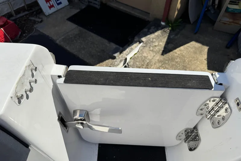 Slide: The Image of 2025 Tidewater 282 CC Adventure boat door with stainless steel hinges and latch. - 6