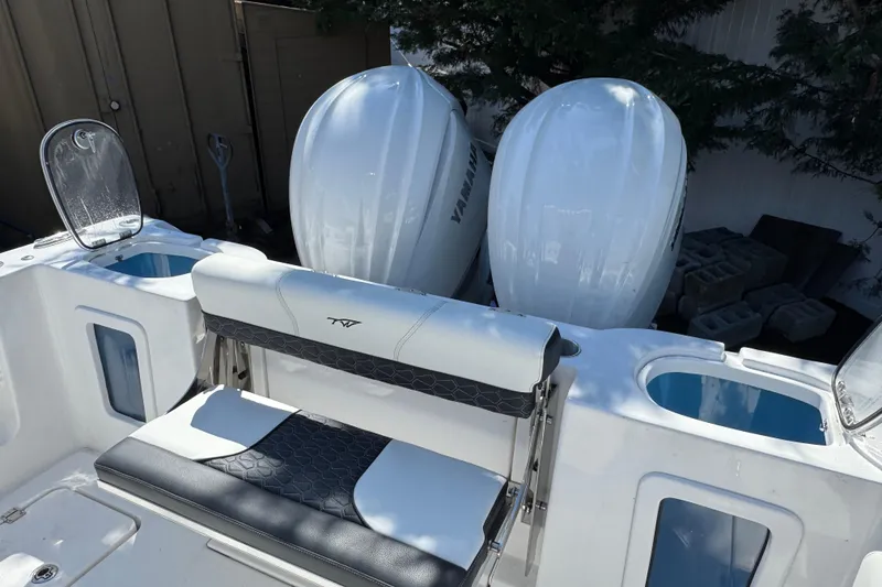 Slide: The Image of 2025 Tidewater 282 CC Adventure boat with dual Yamaha engines and seating area. - 7