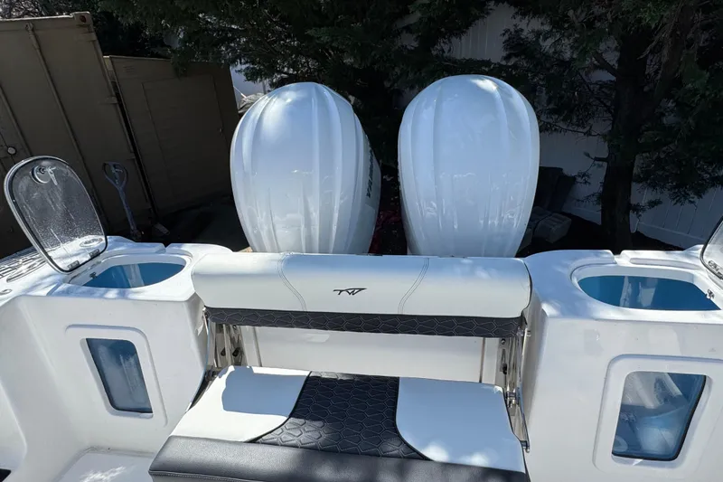 Slide: The Image of 2025 Tidewater 282 CC Adventure boat with dual engines and seating area. - 8