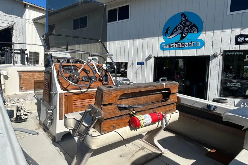 Slide: The Image of 1977 Boston Whaler 19 Outrage boat interior at Salish Boat Co. with wooden console. - 3