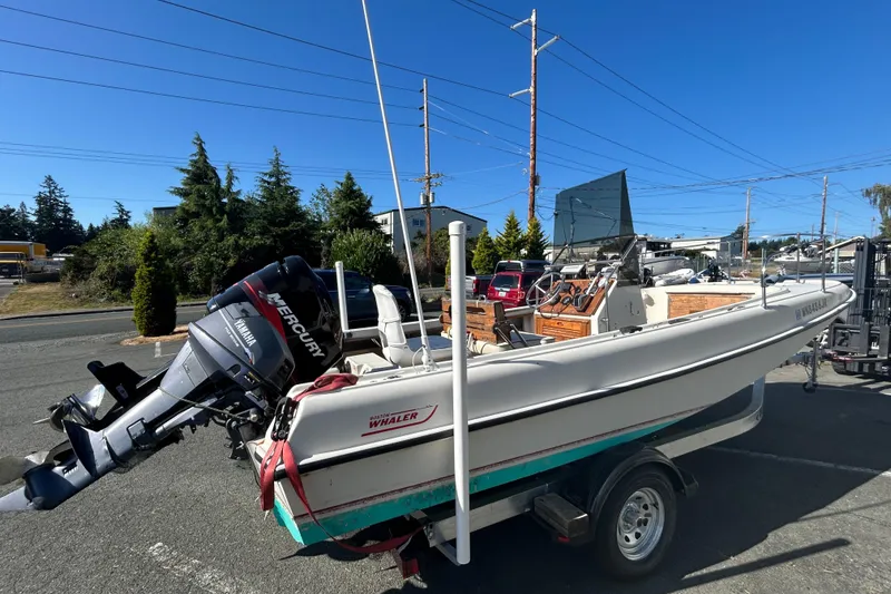 Slide: The Image of 1977 Boston Whaler 19 Outrage boat on trailer with Mercury outboard motor. - 4