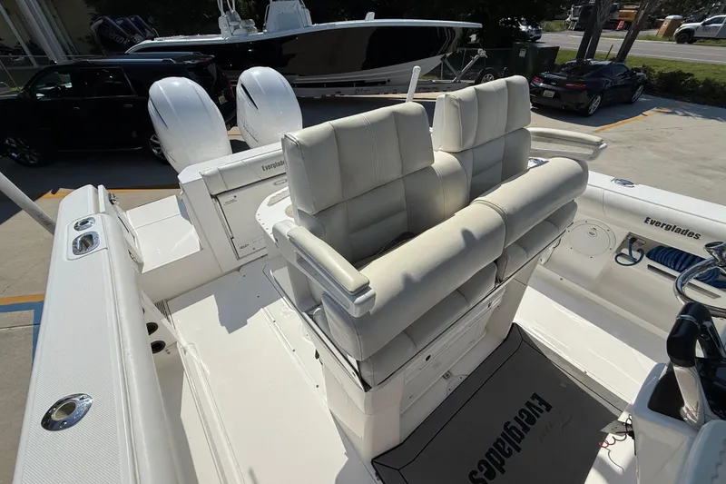 Slide: The Image of 2016 Everglades 255 Center Console boat interior with cushioned seating and dual engines. - 10
