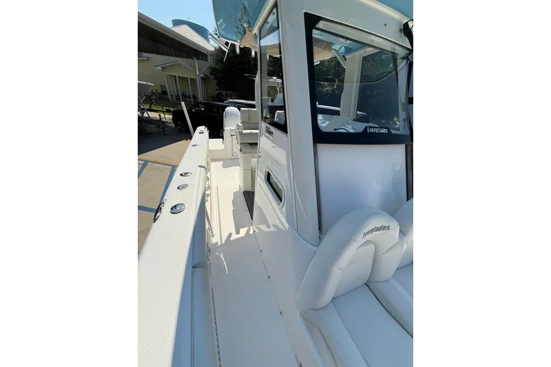 Slide: The Image of 2016 Everglades 255 Center Console boat with sleek white interior and modern design. - 12