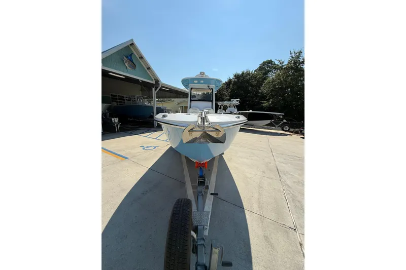Slide: The Image of 2016 Everglades 255 Center Console boat on trailer, parked outdoors under clear sky. - 14