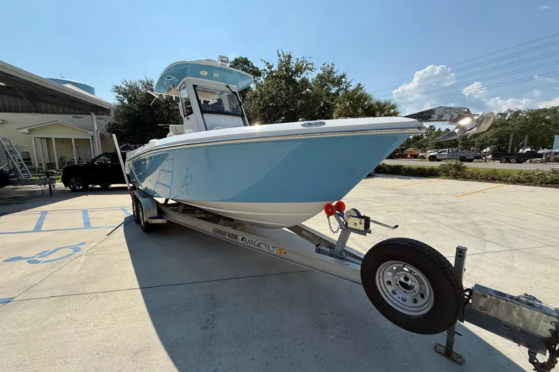 Slide: The Image of 2016 Everglades 255 Center Console boat on trailer in sunny outdoor setting. - 3