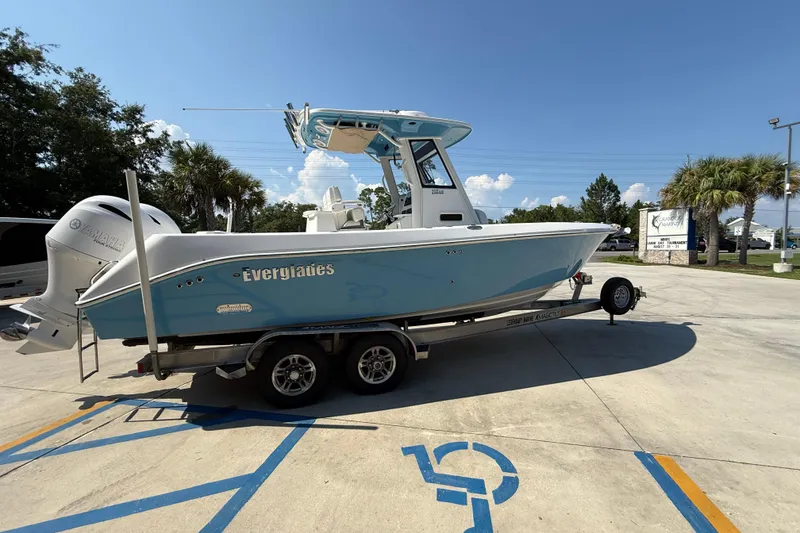 Slide: The Image of 2016 Everglades 255 Center Console boat on trailer in sunny outdoor setting. - 4