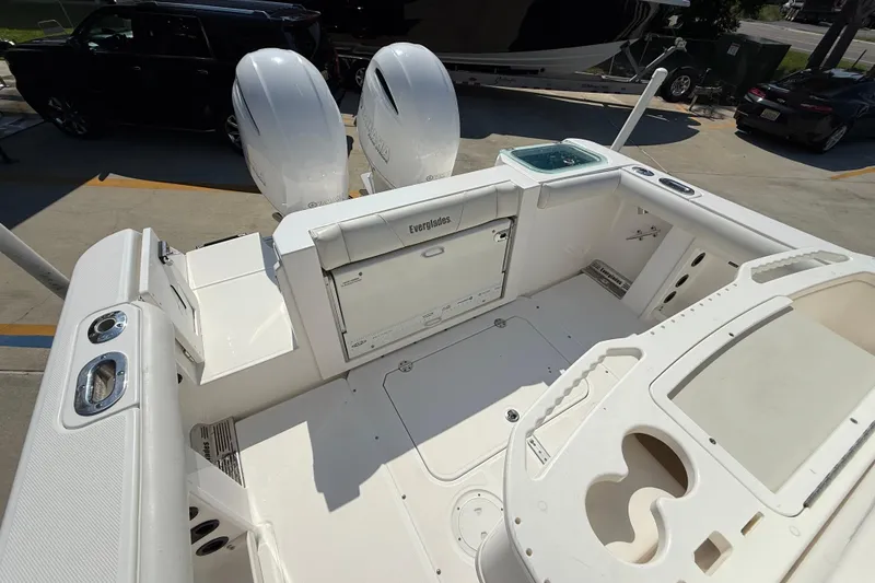 Slide: The Image of 2016 Everglades 255 Center Console boat interior with dual engines and spacious deck layout. - 8