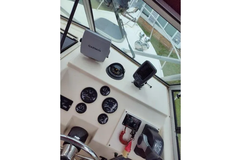 Slide: The Image of 1996 Parker 2110 Walkaround boat dashboard with Garmin navigation system. - 11